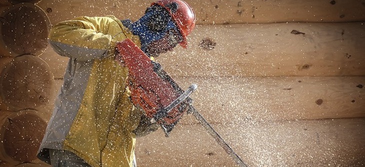 A worker using a chainsaw