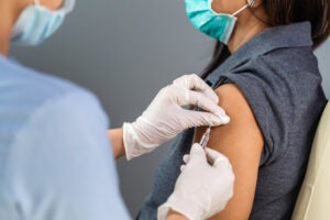 Doctor injecting patient with vaccine