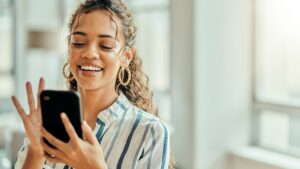 Young-woman-laughing-looking-at-her-cell-phone