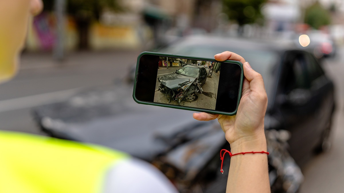 a-person-taking-a-photo-of-an-accident