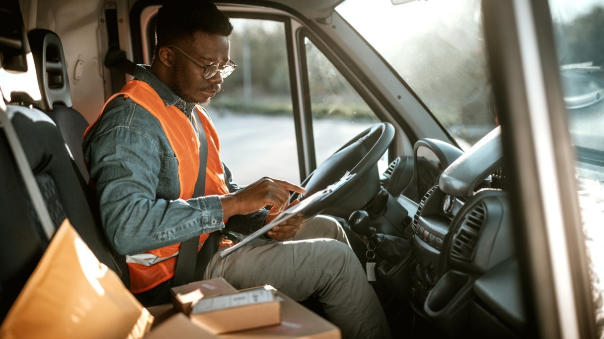 delivery-man-in-orange-vest-in-drivers-seat