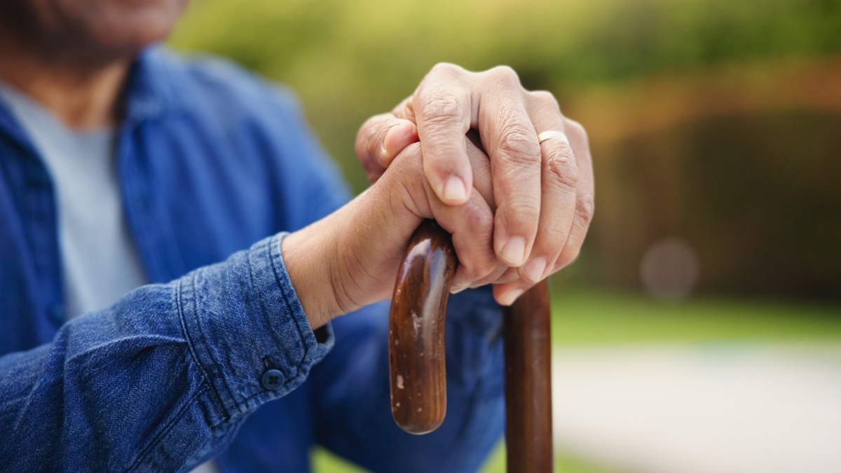 man-with-fatigue-holding-a-cane