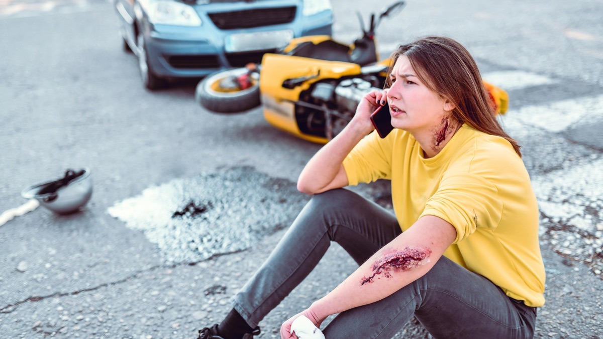 rider-with-road-rash-making-an-emergency-call