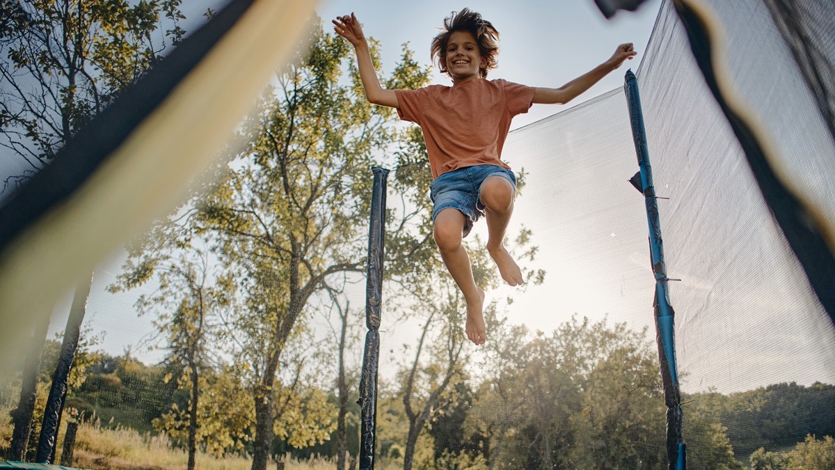 young-boy-jumping-high-on-a-trampoline