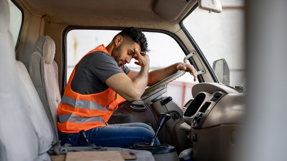 male-worker-tired-at-the-steering-wheel