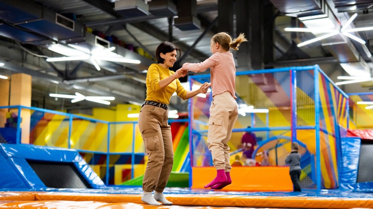 adult-and-child-jumping-at-trampoline-park