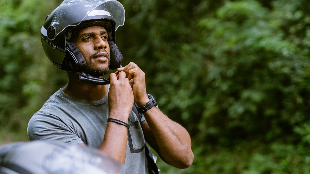 man-adjusting-helmet-before-a-ride