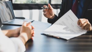 client-signing-paperwork-with-attorney