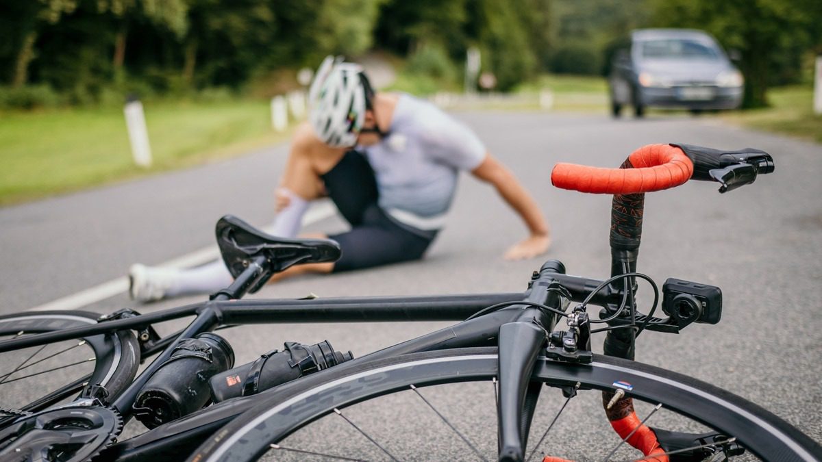 man-holding-leg-in-pain-after-bicycle-accident