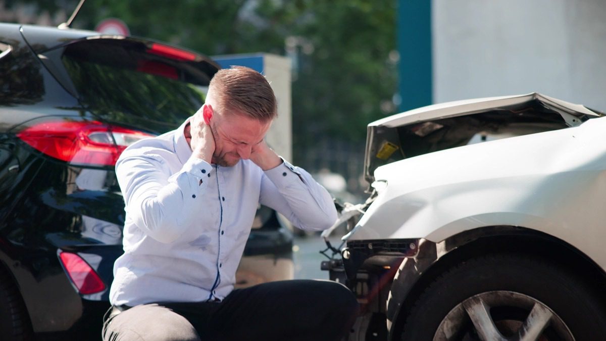 man-holding-neck-after-car-accident