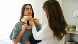 medical-professional-adjusting-neck-brace-on-patient