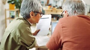 older-couple-looking-over-bills-after-accident
