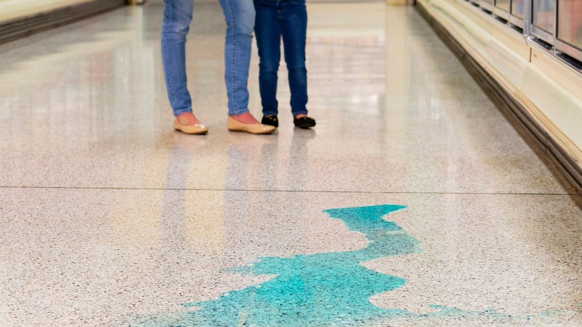 shoppers-standing-near-spilled-liquid-in-grocery-aisle
