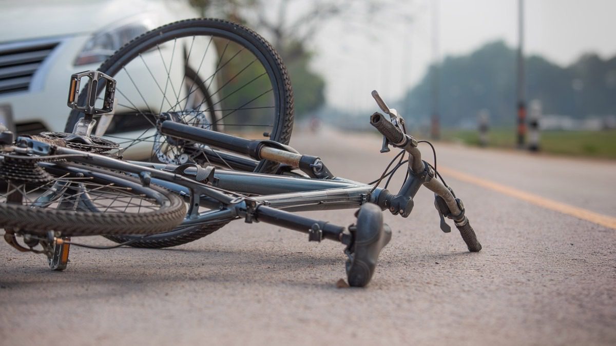 view-of-bike-lying-in-road-in-front-of-a-car