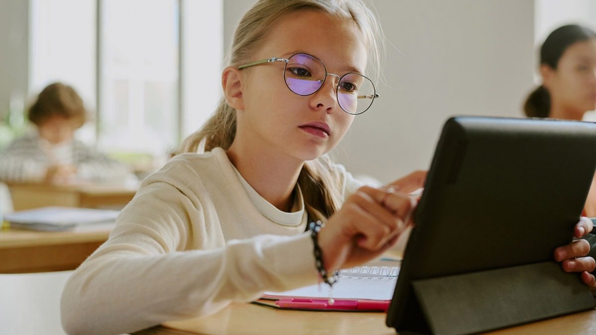 young-girl-using-a-tablet-at-a-desk