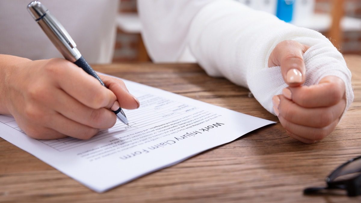Injured-woman-filling-out-work-injury-claim