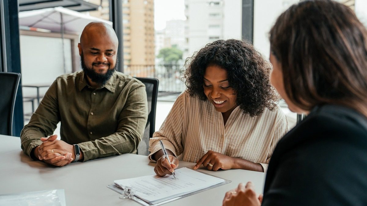 happy-client-signing-settlement-paperwork