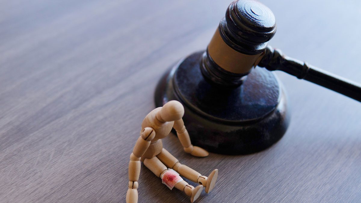 Bandage wrap with blood stain, wooden doll and judge gavel