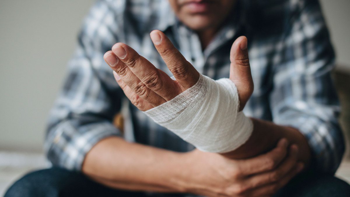 Man with a gauze bandage wrapped around his hand
