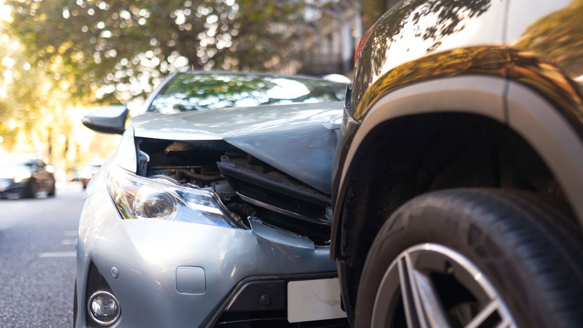 Two damaged vehicles after collision on city street
