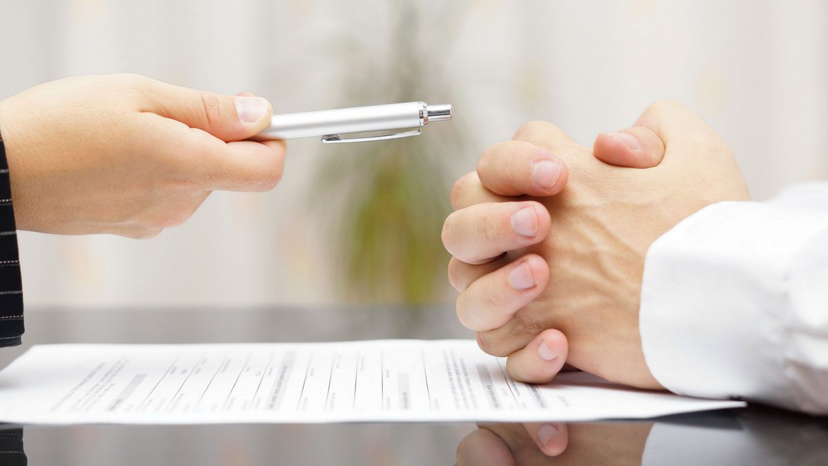 attorney-handing-a-pen-to-a-client