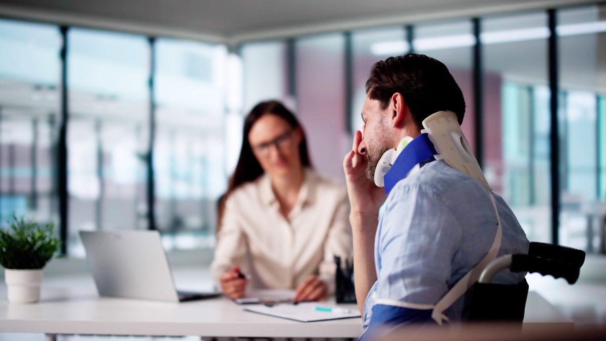 injured man meeting with injury lawyer