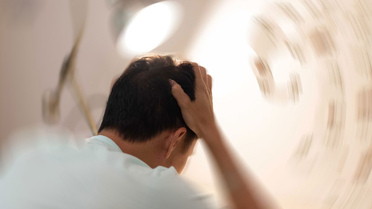 man-experiencing-dizziness-and-holding-head