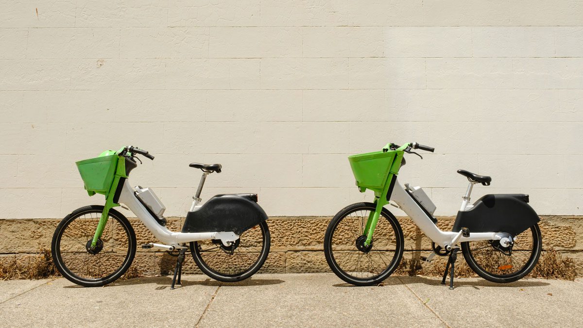 two-electric-bikes-against-a-white-wall
