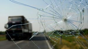 view-from-behind-cracked-windshield-on-road