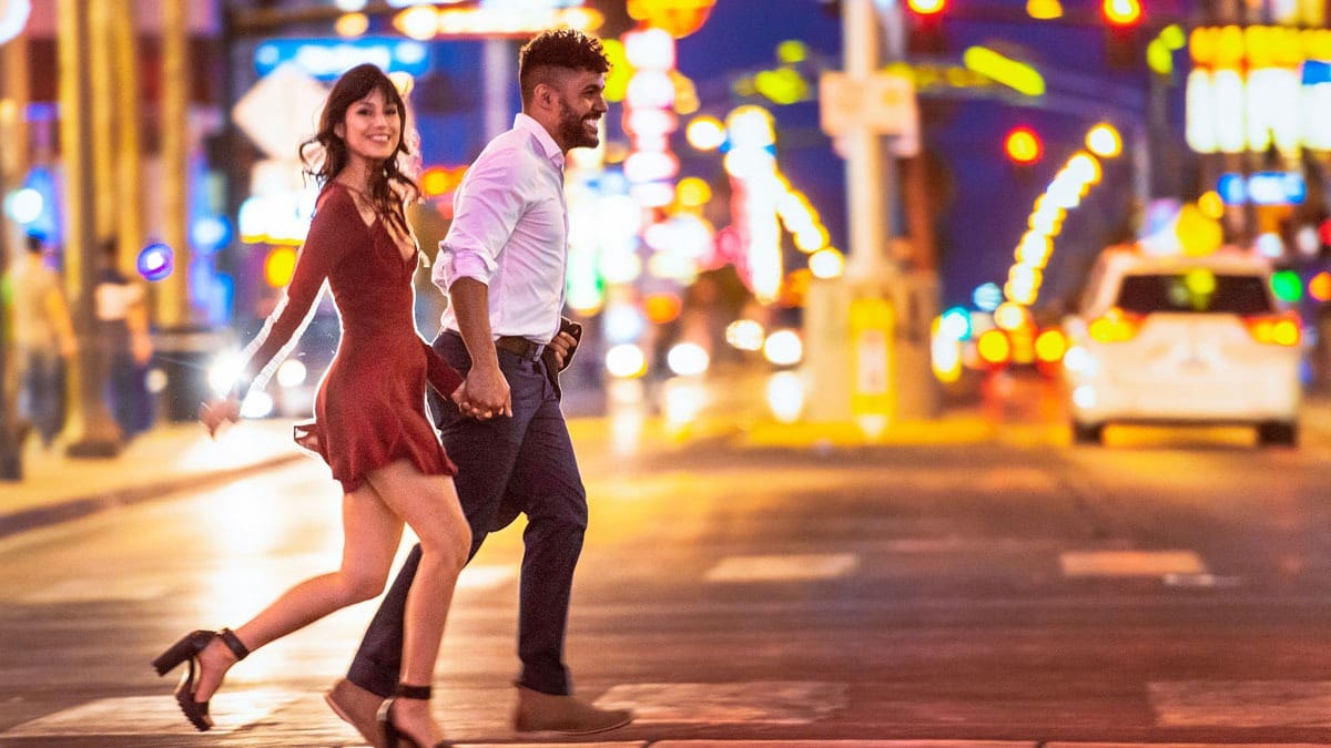 couple-crossing-busy-Vegas-street