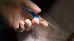 gloved-hand-holding-end-of-port