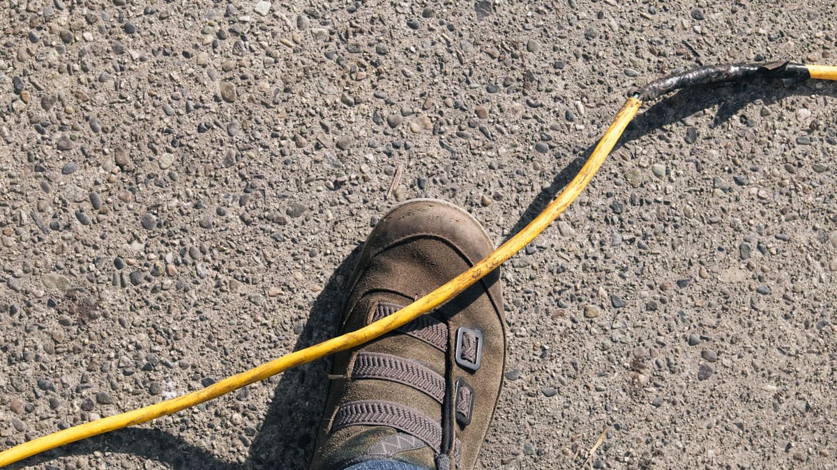man-about-to-trip-on-yellow-cord-on-ground