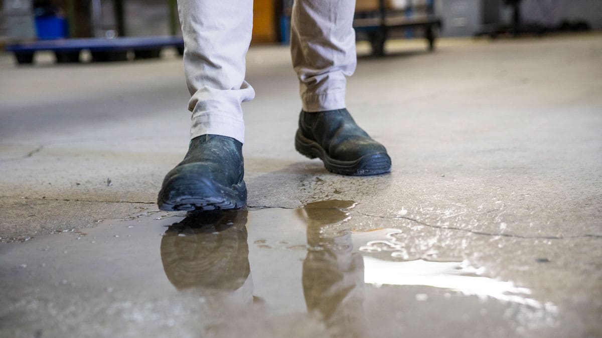 man-walking-near-slippery-floor-area