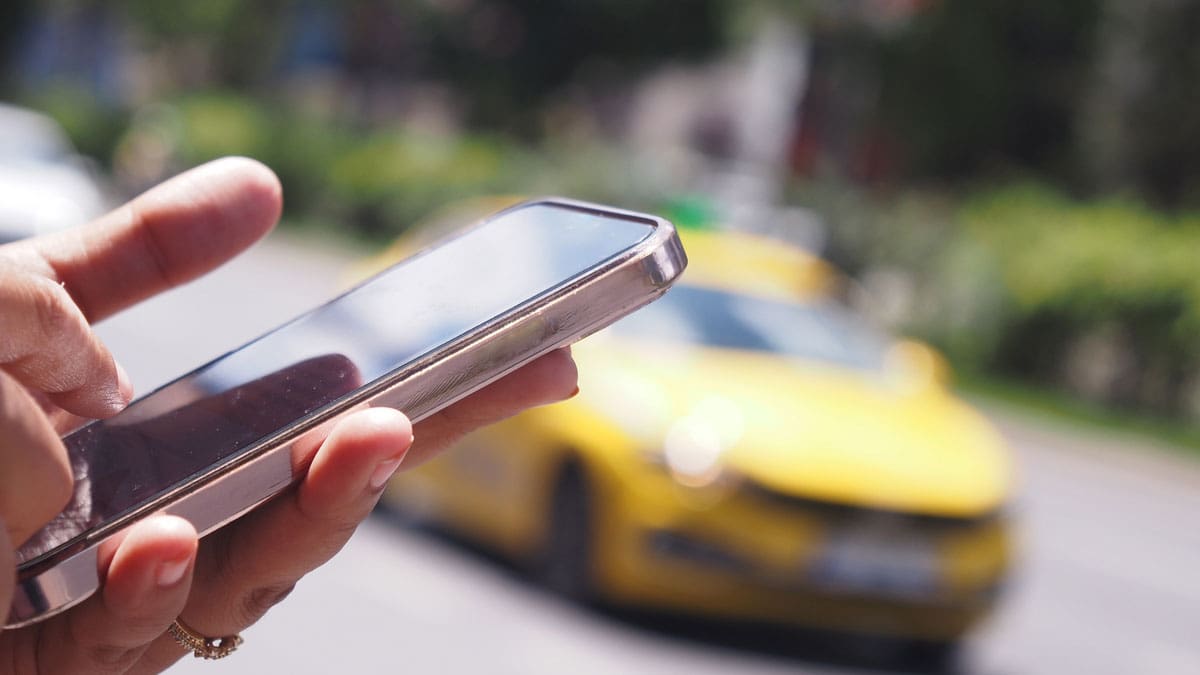person-standing-by-the-street-ordering-a-rideshare-vehicle