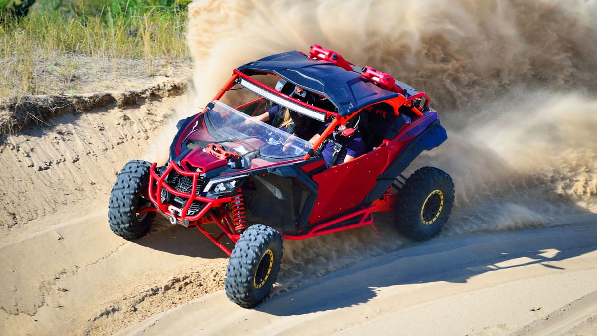 red-off-road-vehicle-kicking-up-dust
