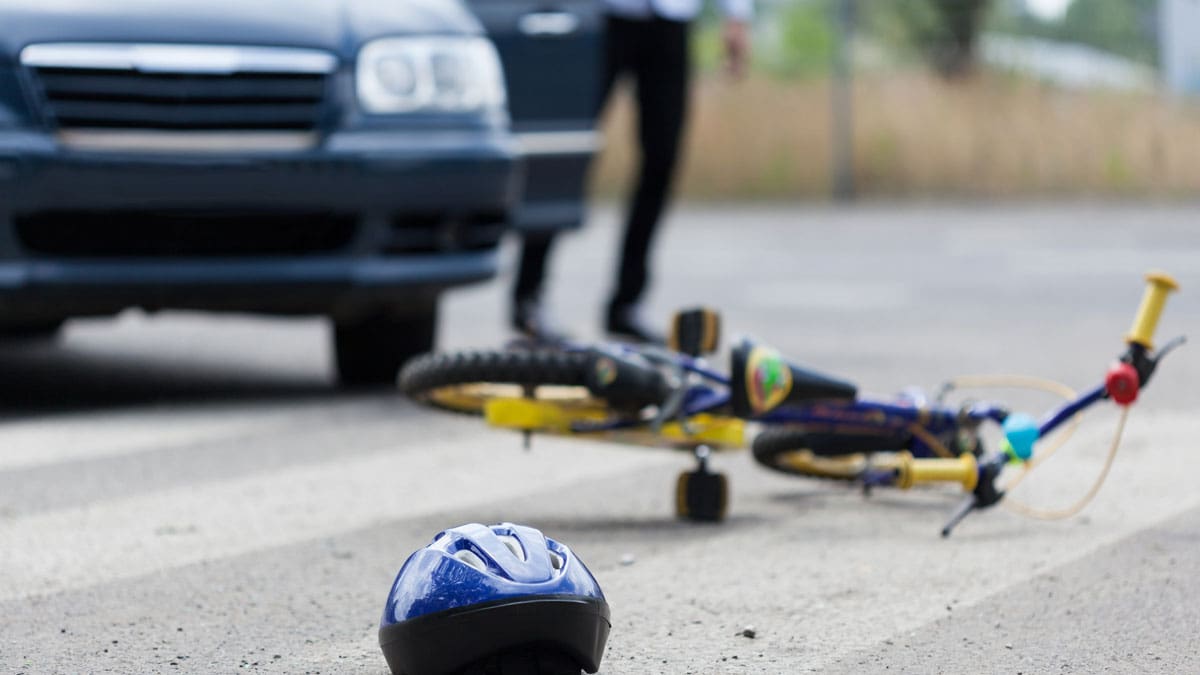 view-of-bike-and-helmet-on-the-ground-near-car