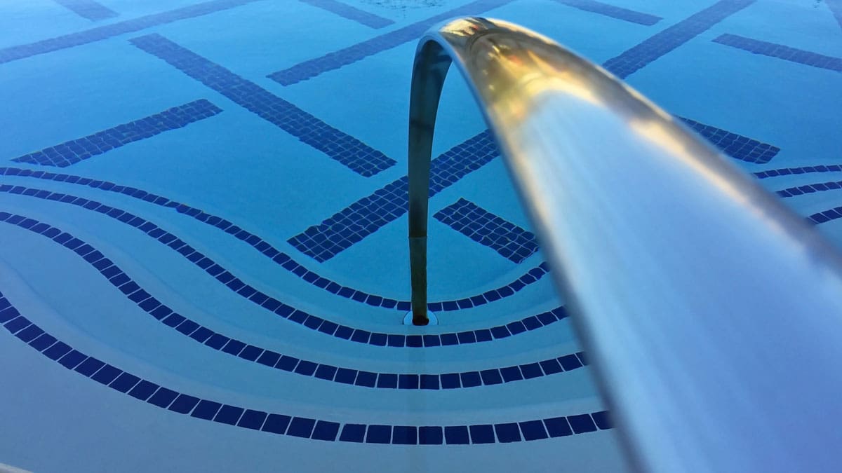 view-of-railing-and-steps-going-down-into-pool