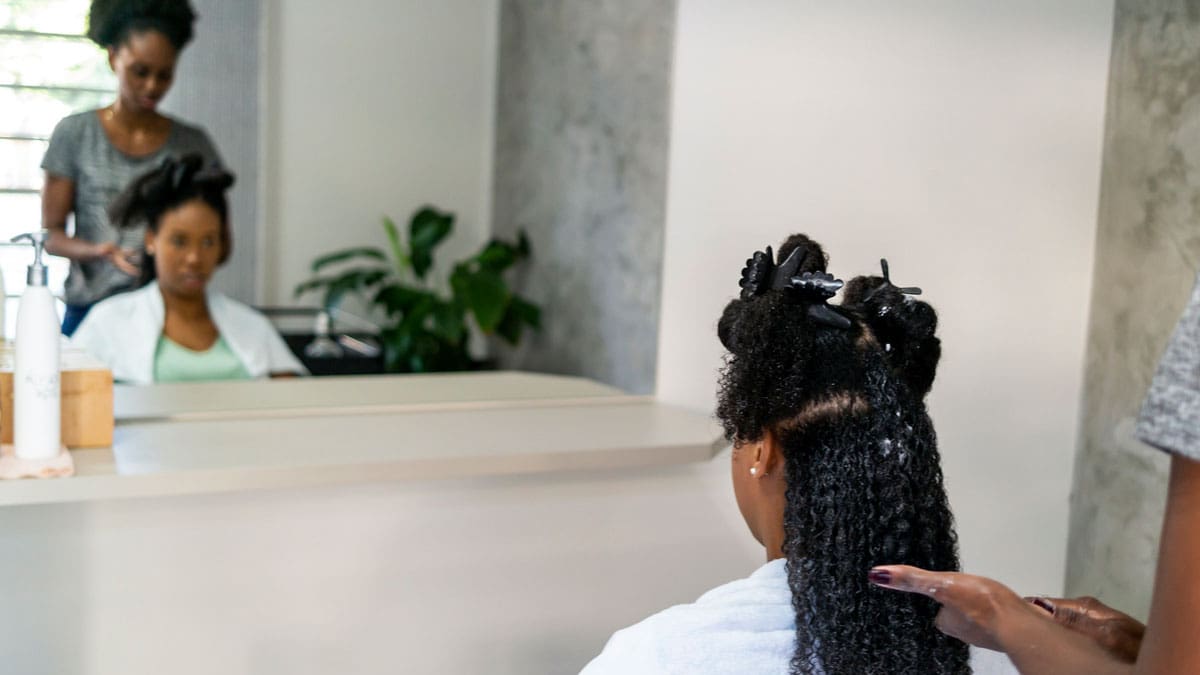 woman-looking-in-mirror-at-stylist