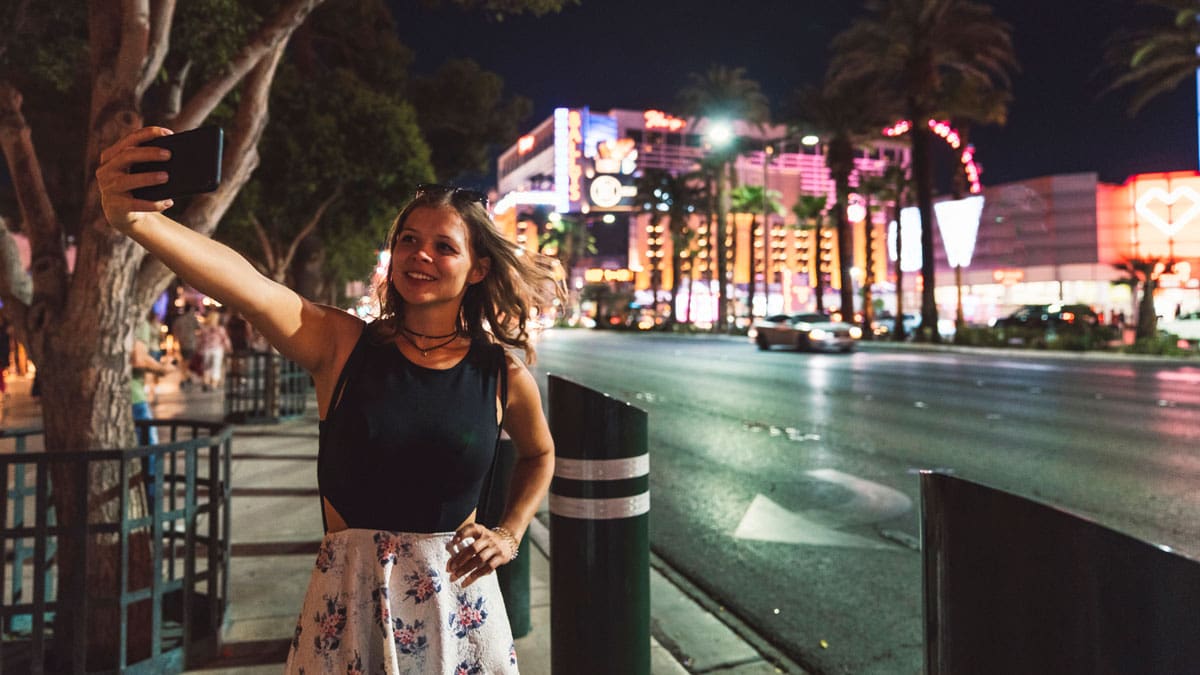 woman-taking-selfie-on-sidewalk