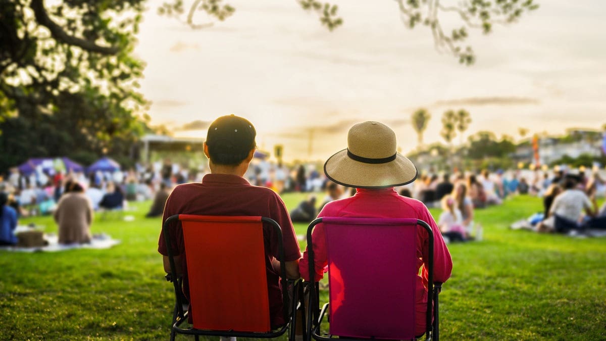 couple-seated-in-lawn-chairs-at-outdoor-show