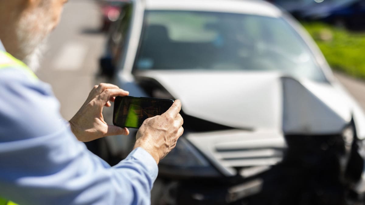 adjuster-photographing-damage-to-a-wrecked-car