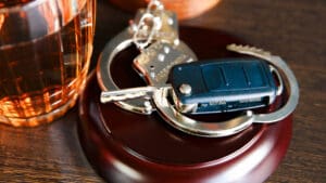 car-keys-beside-a-glass-of-liquor-on-a-table