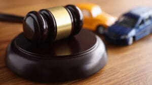 gavel-on-a-desk-next-to-toy-cars