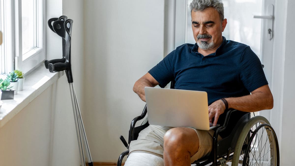 man-in-a-wheelchair-working-on-a-laptop-at-home