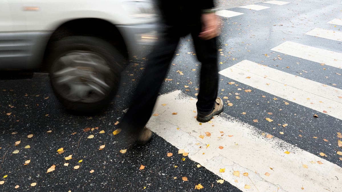 pedestrian-stepping-into-a-crosswalk-as-a-car-approaches