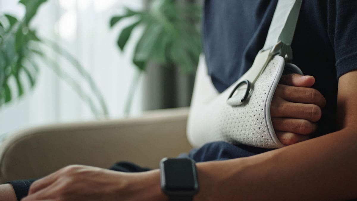 person-in-a-neck-brace-sitting-with-someone-at-home