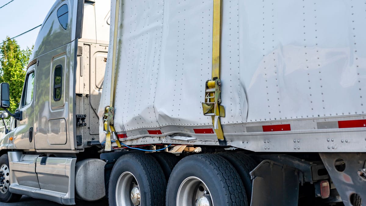 semi-truck-with-a-white-trailer-parked-on-a-street
