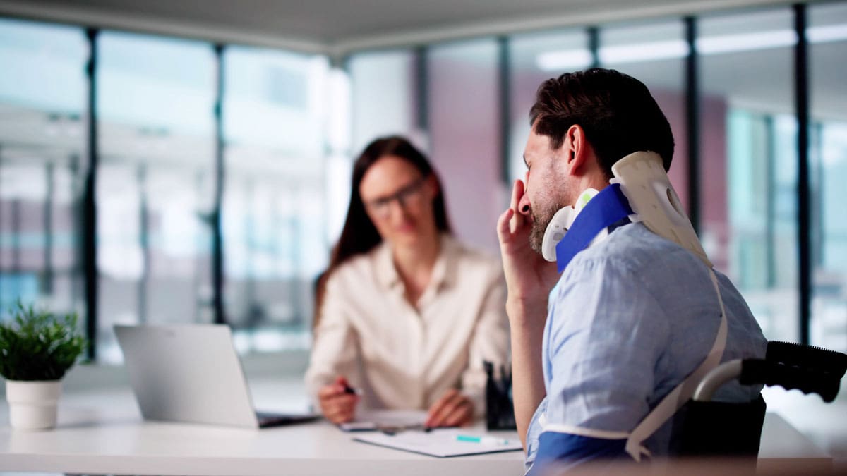 three-people-meeting-at-a-table-in-a-bright-office