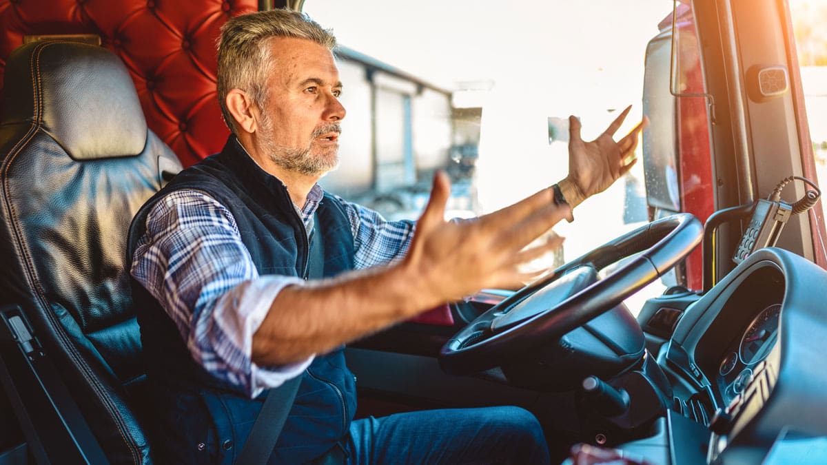 truck-driver-gesturing-with-one-hand-while-driving