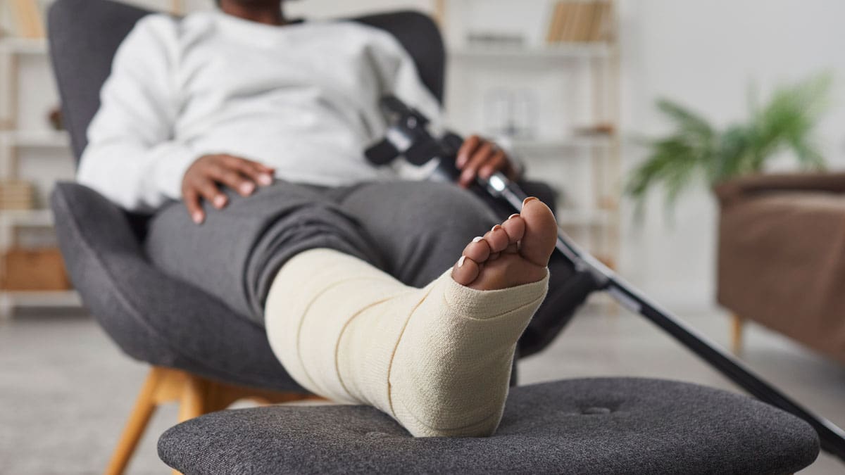 woman-resting-a-leg-in-a-cast-on-an-ottoman